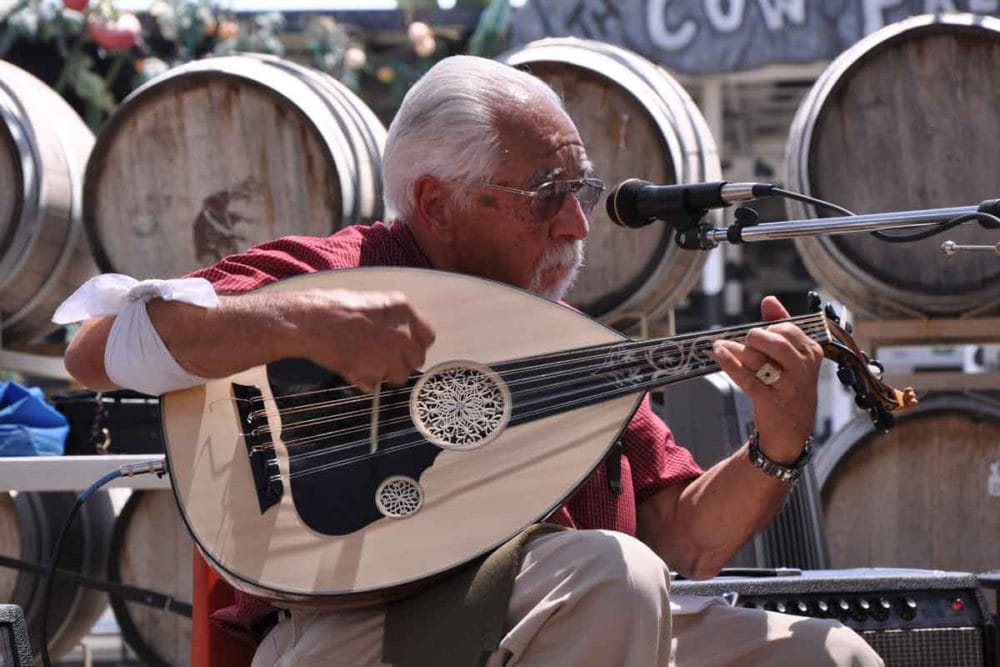 Richard Hagopian playing the oud at the blessing of the grapes ceremony.
